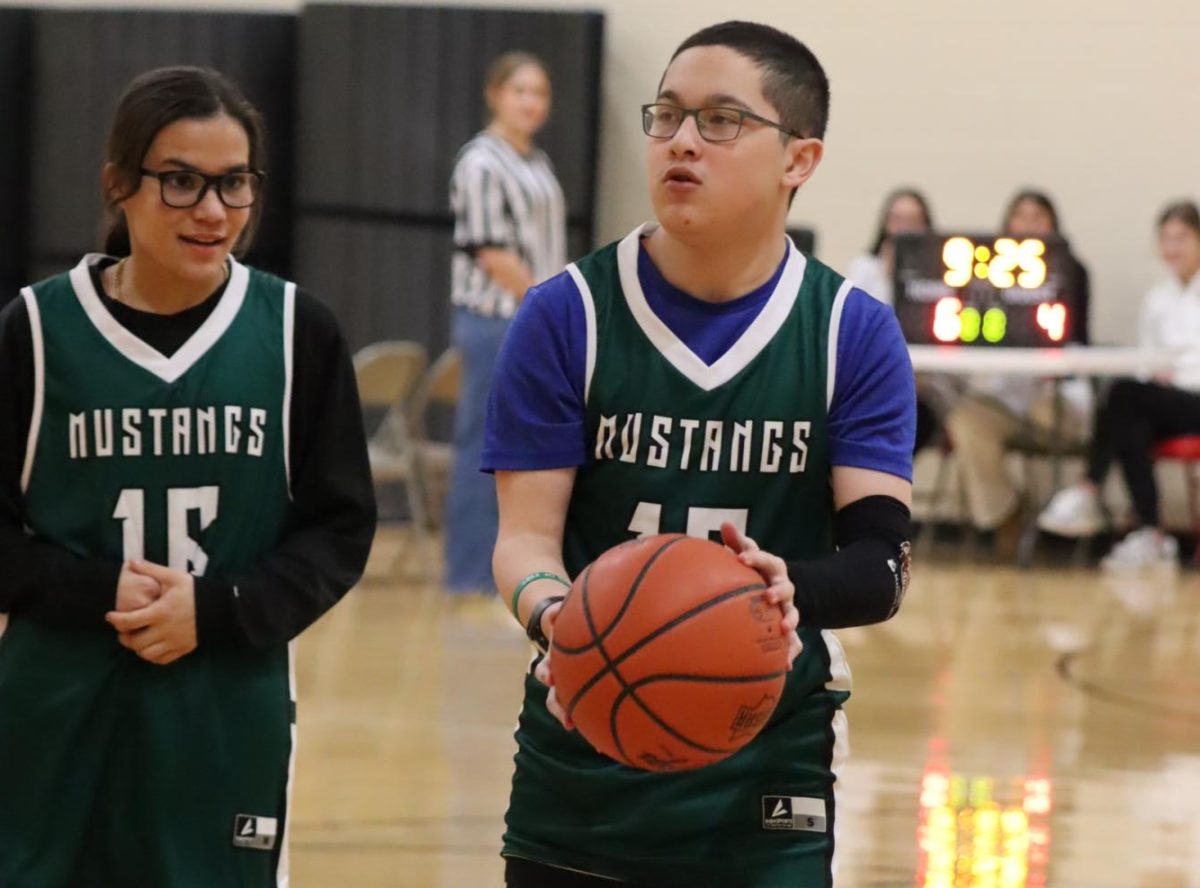 Bobbie Burgoon, freshman, and Blake Beard, junior, compete with Unified Basketball.